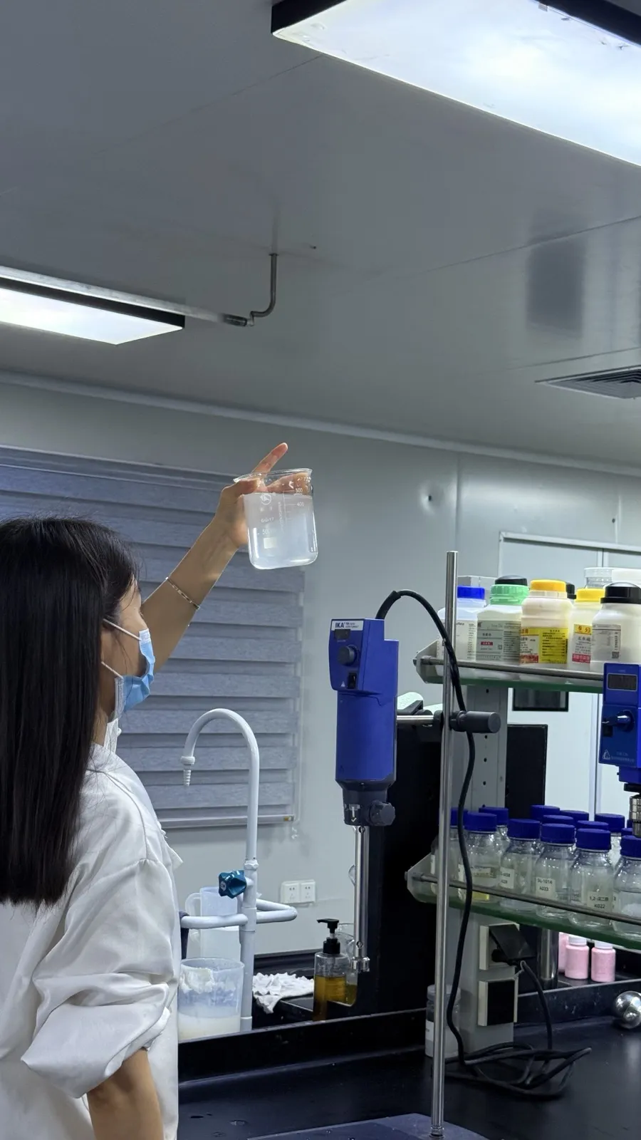 Quality engineer inspecting cosmetics on a contract manufacturer production line